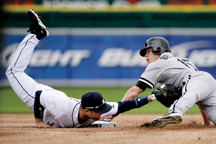 Detroit Tigers second baseman Placido Polanco, a 2009 Gold Glove winner, applies the tag as Chicago White Sox's Gordon Beckham slides into second. Image credit: Duane Burleson - file
