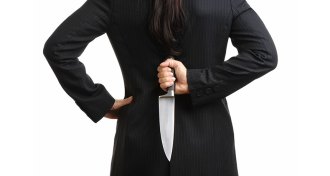 woman holding knife behind her back