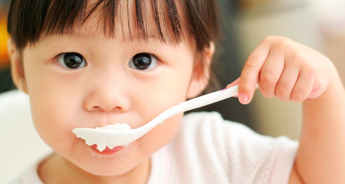 child eating yogurt