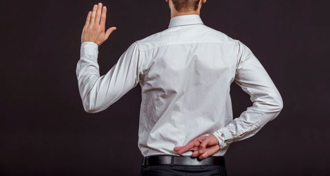 person crossing fingers behind back