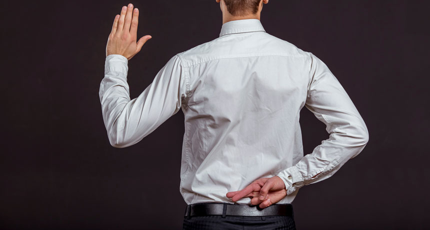 person crossing fingers behind back