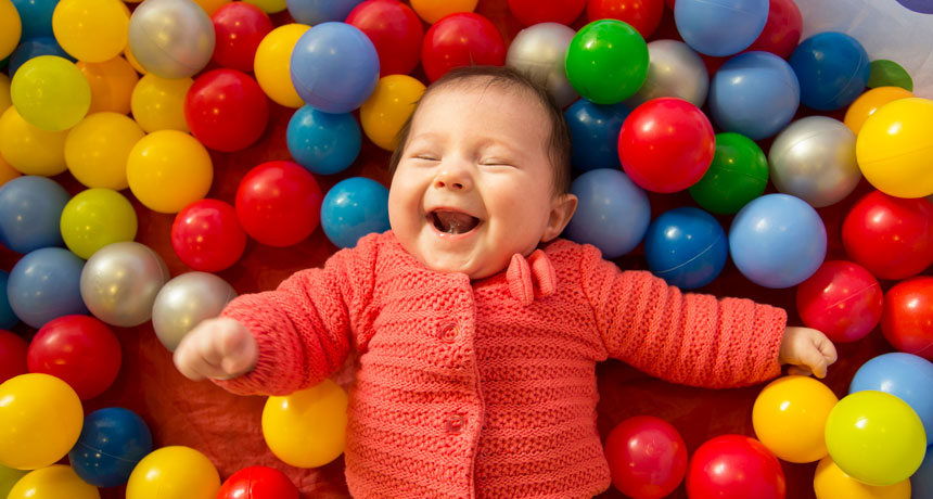 baby in a sensory ball pit