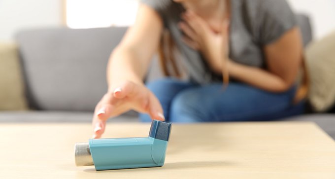 woman reaching for inhaler