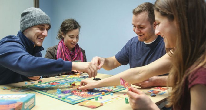 people playing a science board game