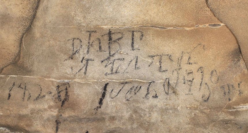 a photo of a Cherokee inscription on the wall of a cave