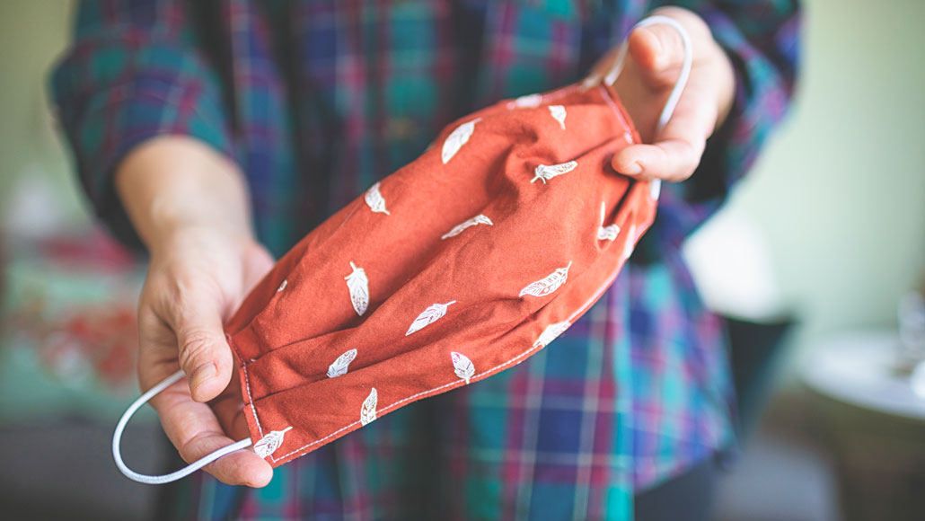 person holding fabric mask