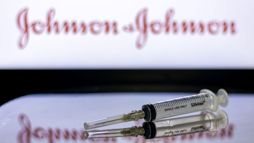 vaccine syringe with Johnson & Johnson logo