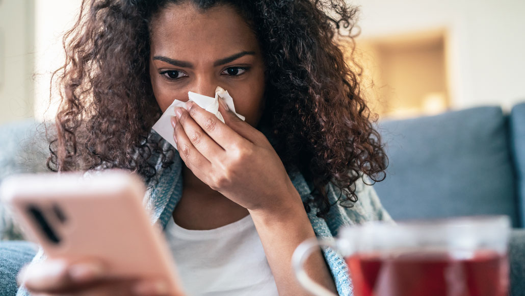 Woman looks at fake health news on her phone