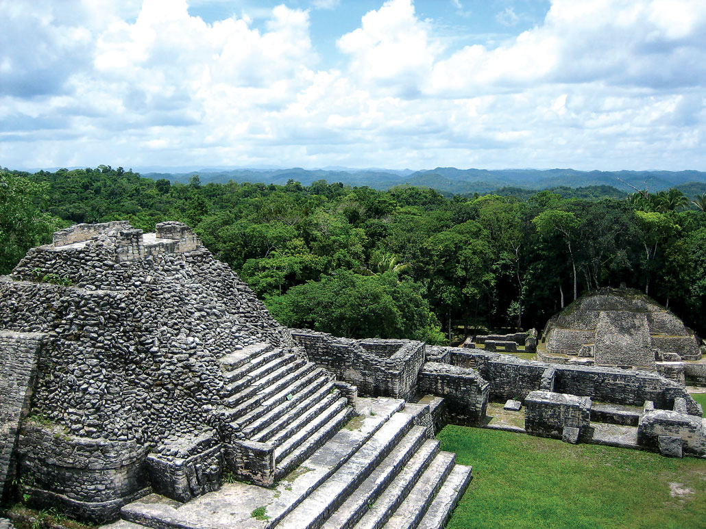 A stone pyramid complex at Caracol with the forest in the background