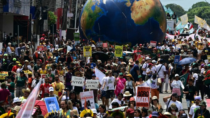 Protestors march outside of COP30 in Brazil